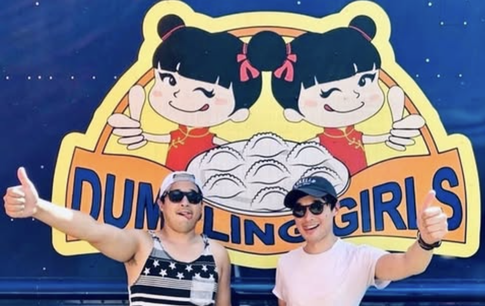 Happy customers giving a thumbs up in front of the Dumpling Girls truck