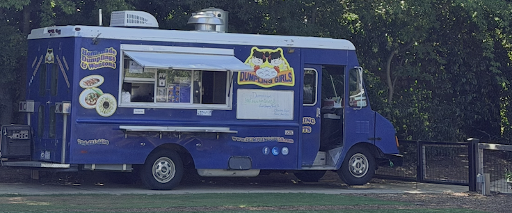Happy customers giving a thumbs up in front of the Dumpling Girls truck